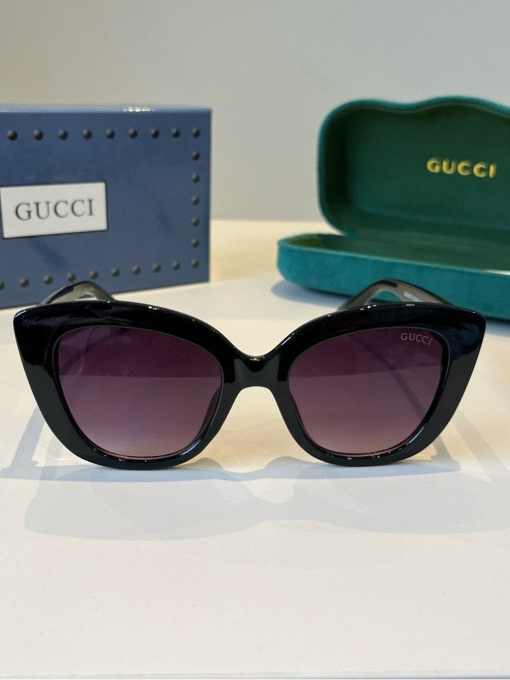 Gucci Glossy Black Cat-Eye Sunglasses with Purple Gradient Lenses